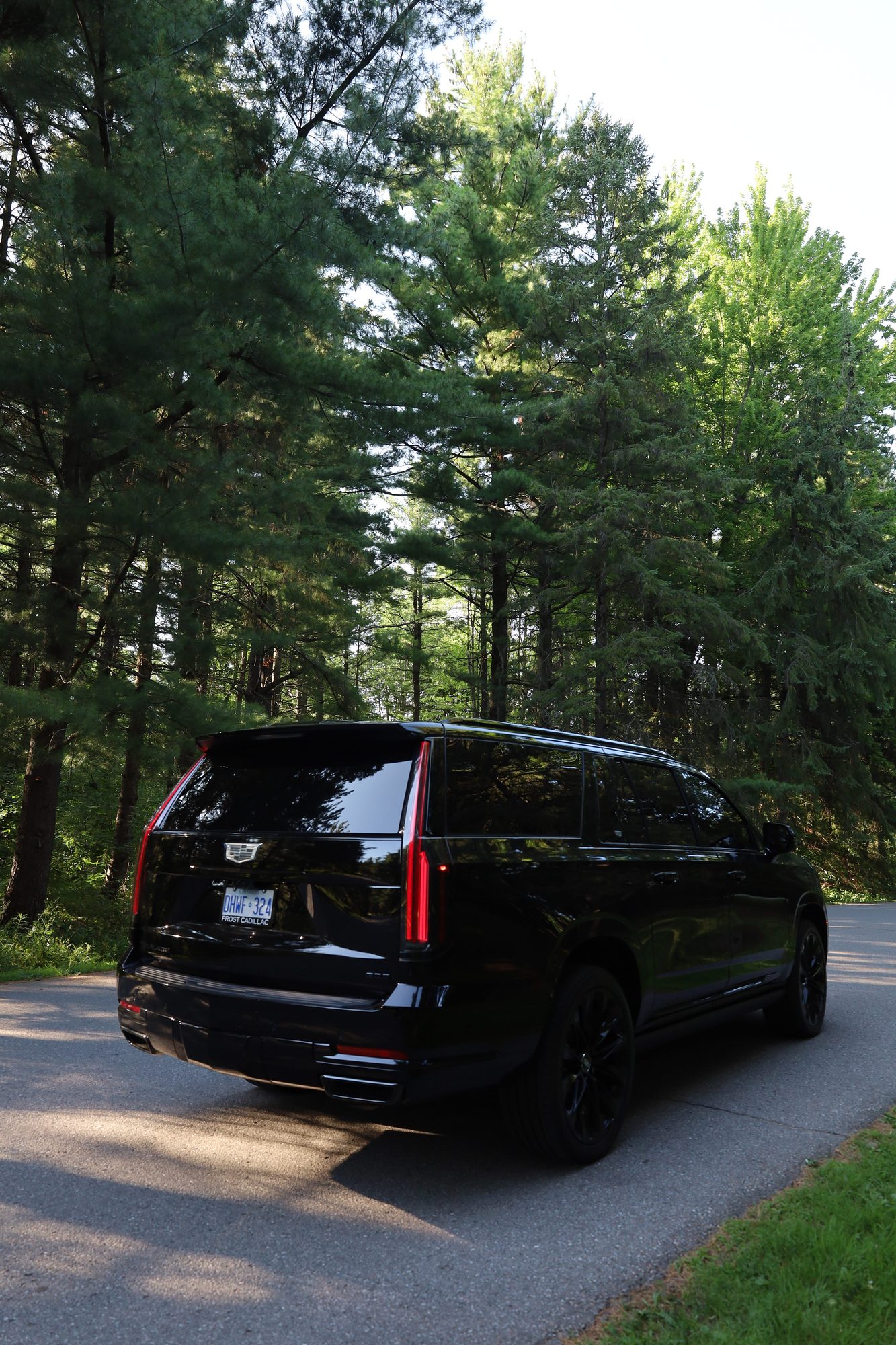 Legacy Limos black Cadillac Escalade — rear three-quarter view
